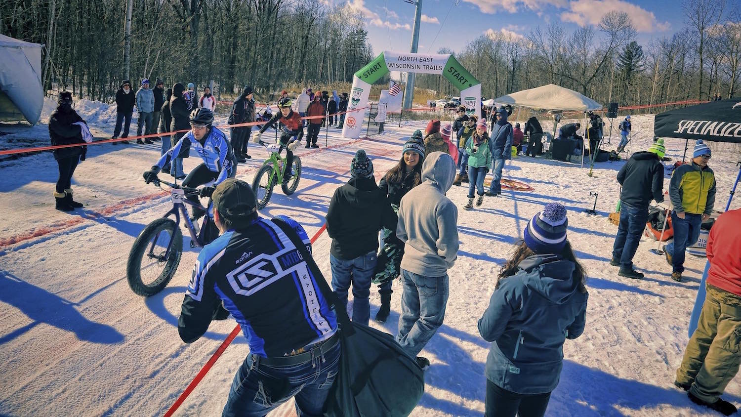 The crowd cheers on competitors at the start/finish line of the Fat Cupid Classic fat bike race.